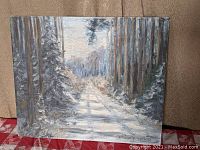 Front view of the oil painting showing the snow-covered road and surrounding pine trees under a muted sky.