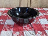 Side view of the black mixing bowl showing glossy finish and shape.