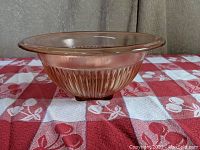 Side view of the pink Depression Era Federal Glass Co mixing bowl showing ribbed pattern and flared rim.