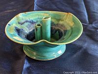 Green glazed pottery with three center cylinders attached for holding flowers, wide round top, pedestal base.