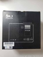 Black box showing illustration and branding of DR. J Professional projector model HI-04.