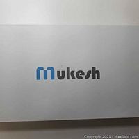 Mukesh branded box showing brand logo on white background.