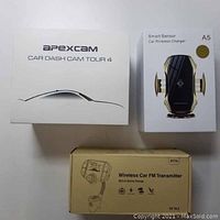 Top view photo showing boxes of Apexcam Car Dash Cam Tour 4, Smart Sensor Car Wireless Charger A5, and Wireless Car FM Transmitter BT70, all unopened.