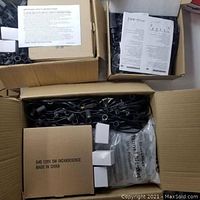 Boxes containing Clear G40 incandescent string lights with black cords, packaging showing bulb specifications.