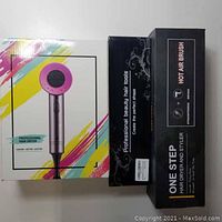 Three boxed hair appliances: professional hair dryer and two 'one step' hot air brush boxes.