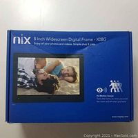 Closed product box of Nix 8 inch widescreen digital frame model X08G with product image and description on front.