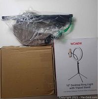 Tripod components and 10 inch ring light box shown side by side.