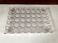 Full top view of the vintage clear acrylic tray showing the grid of circular bubble depressions and slightly raised edges.