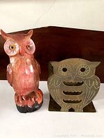 Front view of the wood owl and brass holder showing carved details and color