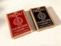 Two vintage Pinochle brand euchre card decks with red and blue boxes labeled 'Two Euchre Packs' made in Canada.