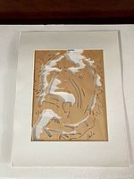 Full overview of the framed wood cut-out artwork showing Mick Jagger's face with white painted highlights and artist signature in the corner.