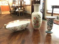 Overall view of the 3 decorative pieces on a wooden table in a well-lit room.
