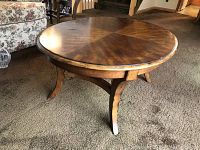 Round wood coffee table showing legs and overall shape