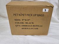 Closed boxed labeled ‘PET N PET PICK UP BAGS’ with product details including size 9"x13", color black, quantity 1080 bags in 60 rolls per case.