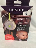 Front view of Hushh white noise machine retail box showing product image and multilingual slogan