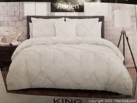 Photo of the comforter set arranged on a bed showing full look and design.