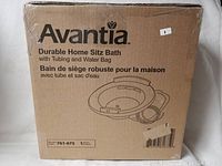 Photo of original sealed packaging box for Avantia Durable Home Sitz Bath with Tubing and Water Bag. Box shows product name, parts included, and a simple line drawing of the sitz bath with tubing and water bag.