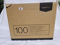 Cardboard box labeled AmazonBasics with '100' prominently displayed and product description in multiple languages.