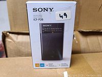 Photo of Sony ICF-P26 FM/AM Radio in original retail box showing front and product image
