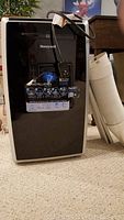 Photo of Honeywell portable air conditioner with vent hose and window inserts beside it