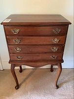 Full front view of cherry flatware chest showing four drawers and Queen Anne style legs