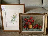 Photo of both framed artworks showing birds print and floral painting side by side.