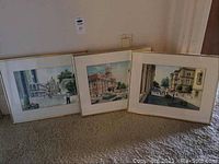Three framed watercolour paintings by Victor Francis arranged side by side