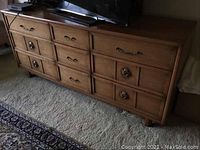 Full side view of the Koehler nine-drawer wooden dresser showing drawer handles and wood tone.