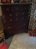 Front view of chest showing overall style, finish, and drawer arrangement