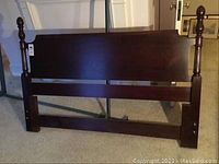Full front view showing mahogany headboard and metal support frame