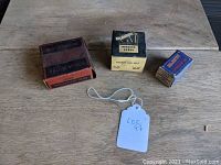 Full lot of three vintage NOS car parts on wooden surface showing all original boxes.