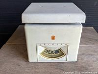 Front view of vintage Detecto scale showing the platform and dial display with brand emblem.