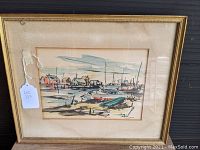 Framed watercolor painting showing the entire harbor scene with boats and houses, mounted under glass in a gold-toned frame with a beige mat.