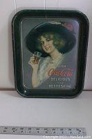 Full view of the metal tray showing a woman holding a glass of Coca-Cola with branding and slogan.