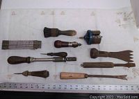 All assorted vintage hand tools arranged for a size and condition overview, including brush, scrapers, cutters, and rulers