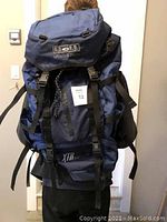 Front view of the Boll Oracle 70+20 backpack worn to show full size and compartments.