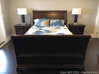 Front view of complete sleigh bed with headboard, footboard and bedding.