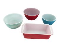 All 4 Pyrex items together showing color and relative sizes: faded light blue, dark blue, red bowls and pink baking dish.