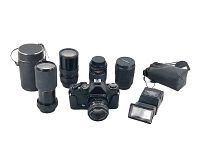 Front view of Gaf L-17 camera with Chinon 55mm lens, additional lenses, and flashlight with cases.