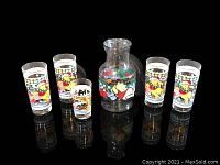 Overview of the glass pitcher and five drinking glasses featuring Winnie the Pooh characters.