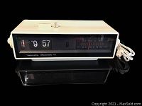 Front view of the tabletop Realistic Chronomatic-113 radio and flip clock, showing the flip clock time at 9:57 and AM/FM tuner markings.
