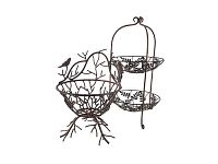 Two metal decor pieces side by side showing the 2-tier stand with leaf designs and the bird motif basket with branch base.