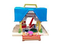 Front view of the Little Tikes Tikes Place Doll House showing the blue roof, red railing patio, table set with pink table and white chairs, green round trampoline, and patio area with two small green bushes.