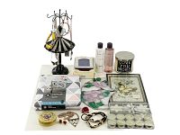 Full lot showing jewelry stand with costume jewelry, candles, tablecloth, decorative tin, stained glass panel, picture frame, Yves Rocher lotion and shower gel, and decorative wall art picture.