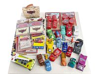 Overview photo showing all included items in the lot, including numerous Cars die cast cars and party favour paper goods.
