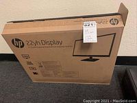 Photo showing HP 22yh Display monitor in original cardboard packaging with seller label.