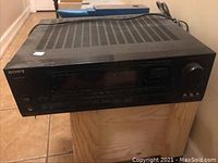 Sony audio video receiver front view showing control panel with volume knob, display, and buttons.