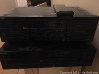 Front view of the two black Sony audio units: cassette player on top, CD player below, with a remote on top of the cassette unit.