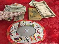 Lot overview showing coupons, Boy Scout diary, and sale catalogue on red textured fabric.