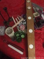 Shows entire lot including wooden tea light candleholder with candles, decorative white ceramic candleholder, green glass candleholders, tapered candles, and assorted candles in plastic bags.